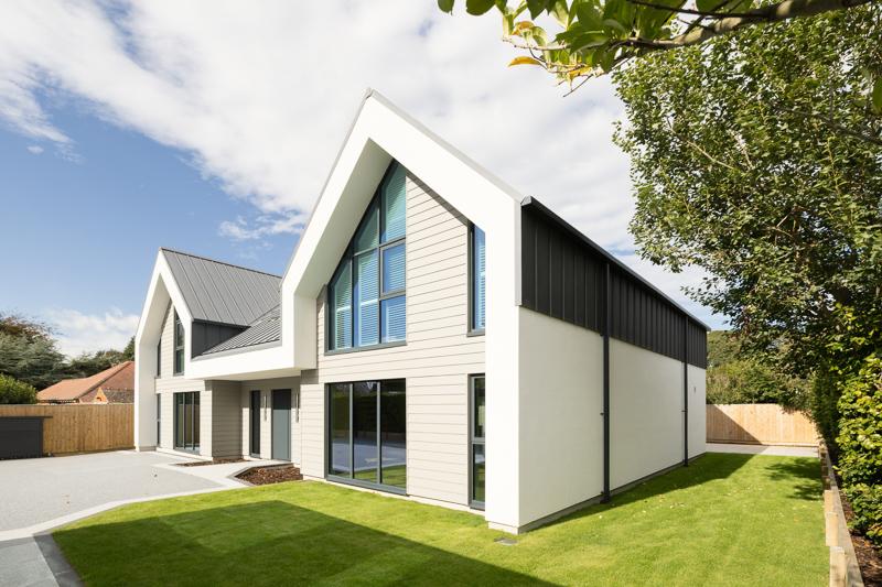 Modern home with white cladding and dark metal accents