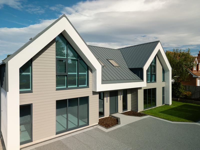Modern residential home with standing seam roof and horizontal cladding