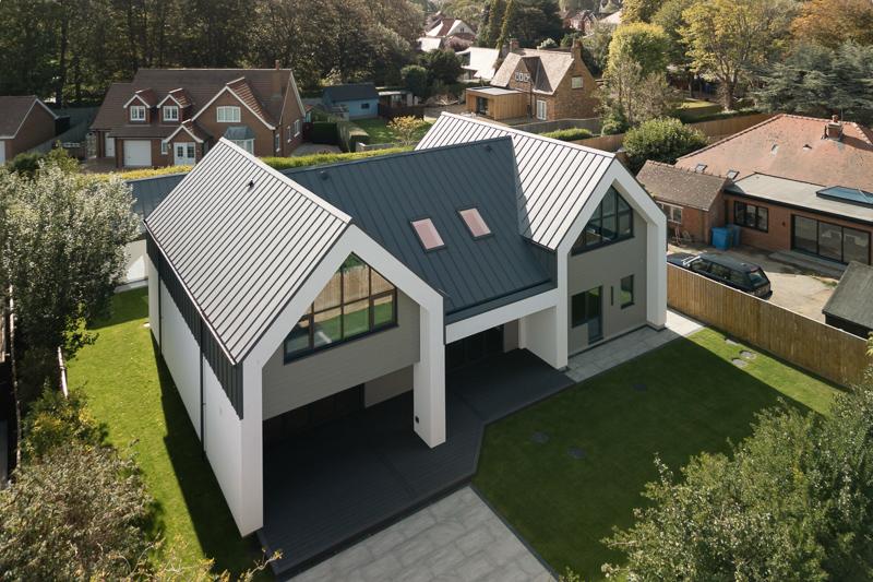 Aerial view of modern home with standing seam roof